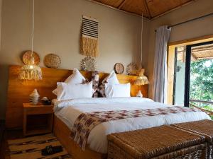 a bedroom with a large bed and a window at Akagera Park Inn in Akagera +113 photos