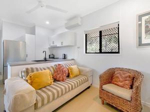 a living room with a couch and a chair at Kadani in Picnic Bay