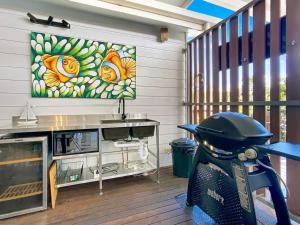 a scooter parked in a room with a painting on the wall at Kadani in Picnic Bay