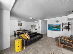 a living room with a black couch and a table at Island View Apt 1 in Arcadia
