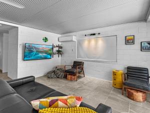 a living room with a couch and a projection screen at Island View Apt 1 in Arcadia