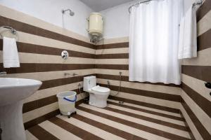 a bathroom with a toilet and a sink at The Himalayan Nomad Manali - 2 bedrooms mountain view independent villas with personal lawn in Manāli +36 photos