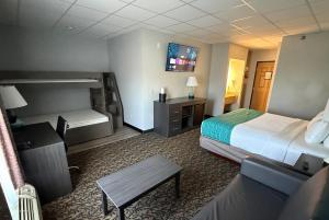 a hotel room with a bed and a couch at Elevation Inn & Suites, Trademark Collection by Wyndham Downtown Rapid City- Walking Distance To The Monument in Rapid City +125 photos
