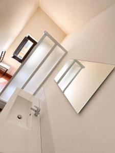 a bathroom with a sink and a mirror at La casa del Borgo in Cetraro