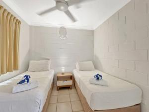 two beds in a room with blue flowers on them at Arcadia Palms 2 in Arcadia