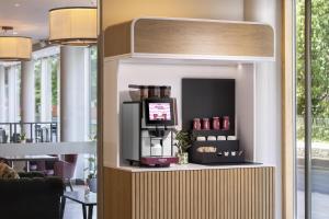 a coffee shop with a tv in a room at Hilton Garden Inn Bristol City Centre in Bristol +69 photos