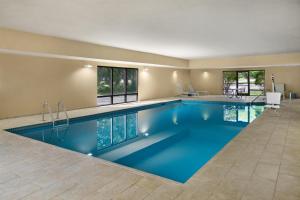 a large pool with blue water in a house at Hampton Inn Janesville in Janesville