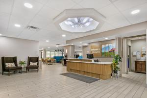 an office lobby with a reception desk and chairs at Hampton Inn Richmond KY in Richmond +26 photos