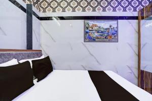 a room with a bed and a picture on the wall at Hotel Gaurav in Ahār