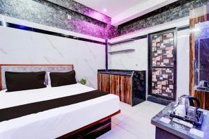 a bedroom with a large bed and a bathroom at Hotel Gaurav in Ahār