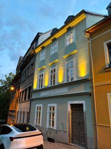 a white car parked in front of a building at Monte-Rosa in Karlovy Vary
