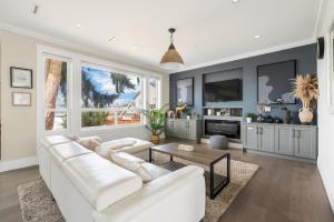 a living room with a white couch and a table at 5-Star Luxury and comfortable home in New Westminster