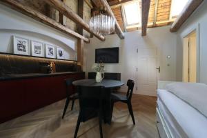 a room with a table and a bed and a bedroom at Monte-Rosa in Karlovy Vary
