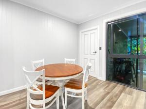 a dining room with a wooden table and chairs at Magnetic Reef Unit 2 in Arcadia