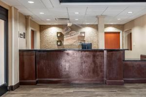 a lobby with a large wooden reception desk at Comfort Inn & Suites Clinton - Jackson West in Clinton +20 photos