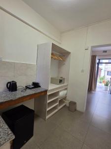 a kitchen with a counter and a counter top at Cotton Beach Holidays in Saint Francois