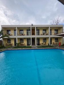 a large pool in front of a building at Cotton Beach Holidays in Saint Francois