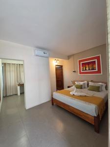 a bedroom with a large bed in a room at Cotton Beach Holidays in Saint Francois