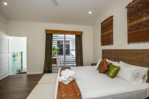 a bedroom with a large white bed and a window at Reflections Topaz Villa 3 in Picnic Bay