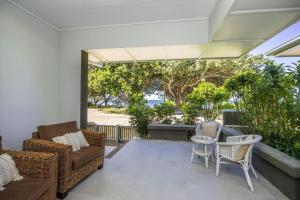 a living room with a couch and chairs on a balcony at Reflections Topaz Villa 3 in Picnic Bay +11 photos