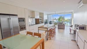 a kitchen with a table and a counter top at Blue on Blue Apartment 932 in Nelly Bay