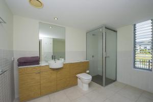 a bathroom with a toilet and a sink and a shower at Blue on Blue Apartment 912 in Nelly Bay