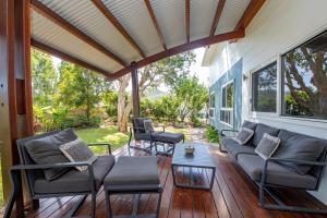 a screened in porch with a couch and chairs at The Wave in Horseshoe Bay +21 photos