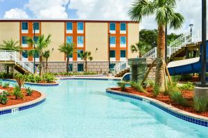 a pool at a resort with a water slide at Radisson Hotel Orlando Lake Buena Vista South in Kissimmee