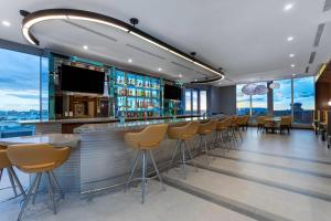 a bar in a building with chairs and tables at Wyndham Garden Miami International Airport in Miami