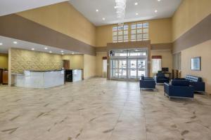 a lobby with a large room with couches and tables at Radisson Hotel Edmonton Airport in Leduc