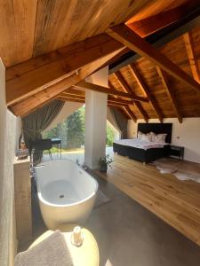 a large bathroom with a tub and a bed at chata Jarka in Jivno +20 photos