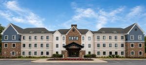 a large white building with a gate in front of it at Staybridge Suites Columbia - Baltimore by IHG in Columbia