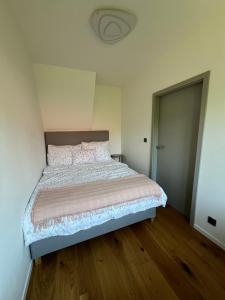 a bedroom with a large bed with a wooden floor at chata Jarka in Jivno