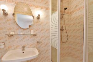 a bathroom with a sink and a shower at Manoir De Labelangerie in Acqueville