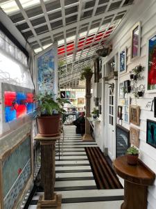 a hallway of a store with plants on the walls at Little bird in Smithton