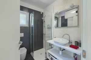 a bathroom with a sink and a shower and a toilet at Holiday House Altea in Banjole +90 photos