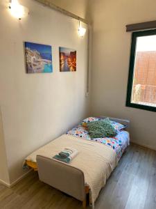 a small bedroom with a bed in the corner at Salento Sunny Flat in Aradeo