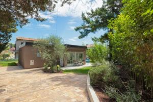 a house with a brick driveway in front of it at Holiday House Altea in Banjole