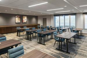 a dining room with tables and chairs and windows at Four Points by Sheraton Rock Springs in Rock Springs +54 photos