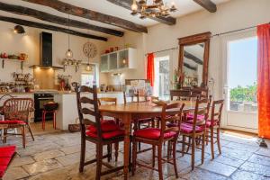 a kitchen and dining room with a wooden table and chairs at Chez Bacchus - Chambres in Gras +55 photos
