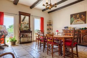 a dining room with a wooden table and chairs at Chez Bacchus - Chambres in Gras
