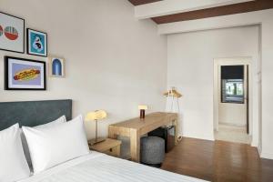 a bedroom with a bed and a desk at FOUND Hotels, Chicago, Series by Marriott in Chicago