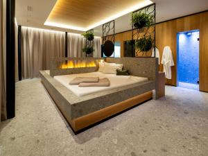 a bedroom with a large bed with a fireplace at Hotel von Rotz in Wil
