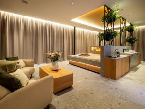 a living room with a couch and a bed at Hotel von Rotz in Wil