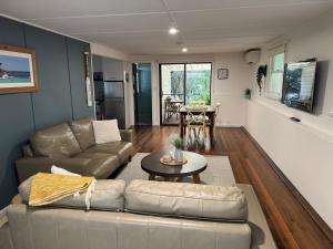 a living room with a couch and a table at Boatsheds in Sawtell