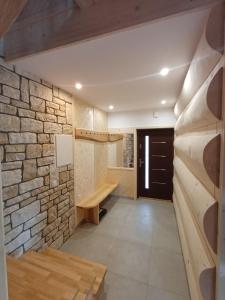 a room with a stone wall and a wooden bench at Domek u Szwajnosów in Ciche +23 photos