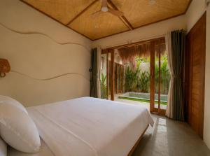 a bedroom with a white bed and a sliding glass door at Villa Xana - Private pool - SOFT OPENING in General Luna +15 photos