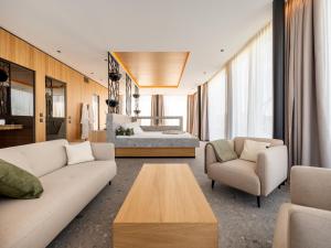 a living room with a couch and a bed at Hotel von Rotz in Wil