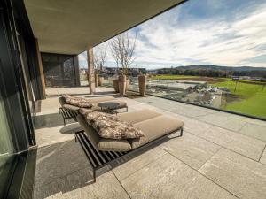 a patio with two couches and a large window at Hotel von Rotz in Wil