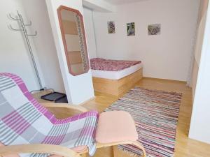 a room with a bed and a chair and a rug at Dürnberger in St Martin in Scheffsnoth
